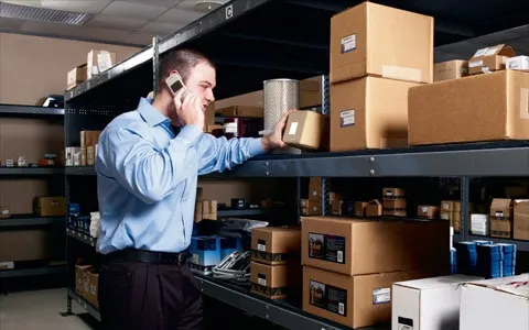 Man on the phone checking the box label